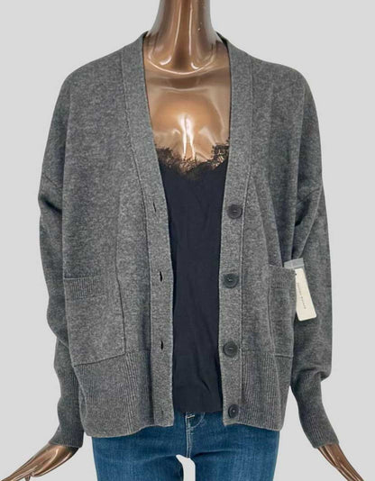 BROCHU WALKER Lace Looker cardigan in charcoal grey with 70% wool and 30% cashmere blend. V-neckline with four-button closure. Signature lace detail panel at center front attached to sweater for layered effect. Two patch pockets at front. 
