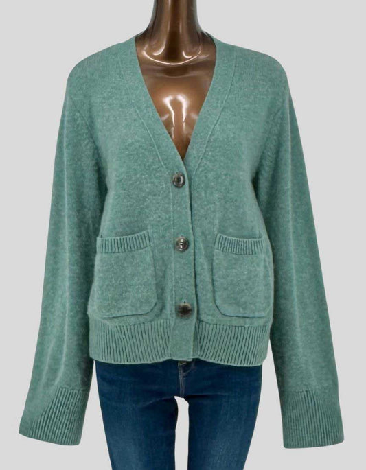 LISA YANG button-front cardigan in 100% cashmere with seafoam green finish. V-neckline with button closure, long sleeves with ribbed cuffs, two patch pockets at waist, and ribbed hem. Relaxed fit construction