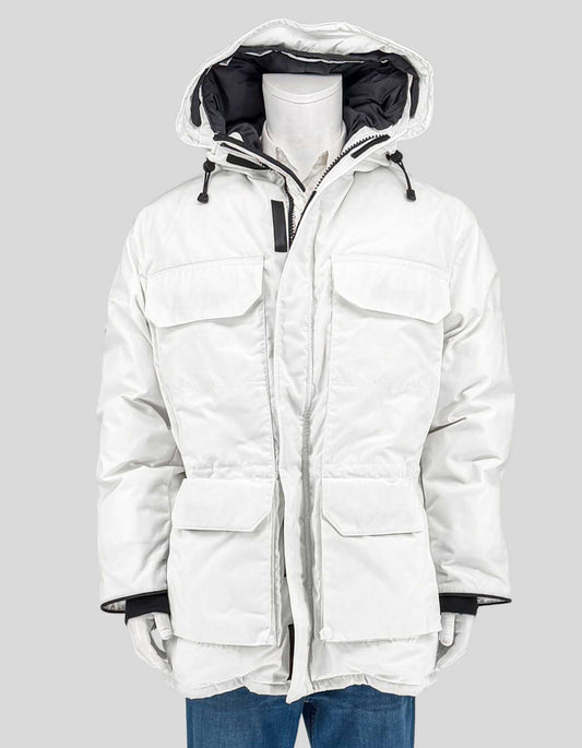 CANADA GOOSE's iconic Expedition Parka in white Arctic-Tech shell with black nylon lining. Six exterior pockets, drawstring down-filled hood, elasticized snow skirt, and 625-fill duck down insulation rated for extreme cold.
